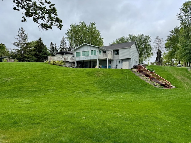5578 Seaburg Rd SE, Osakis, MN 56360 - rear view of house featuring a wooden deck, stairs, and a lawn