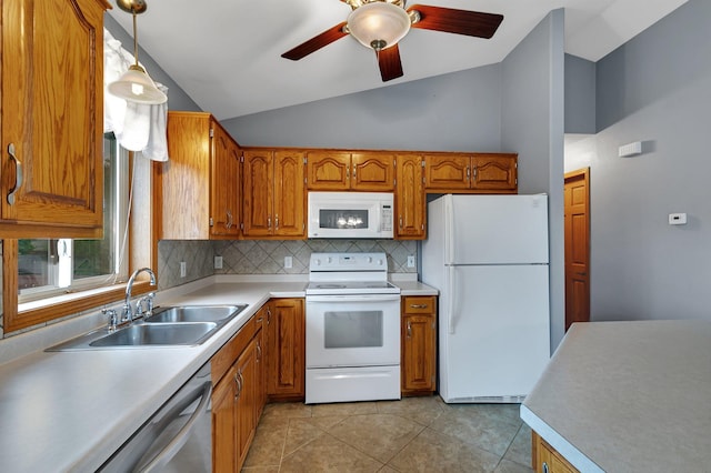 kitchen with white appliances, vaulted ceiling, a sink, brown cabinetry, and decorative backsplash