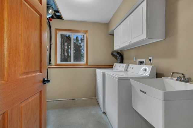 washroom featuring cabinet space and separate washer and dryer