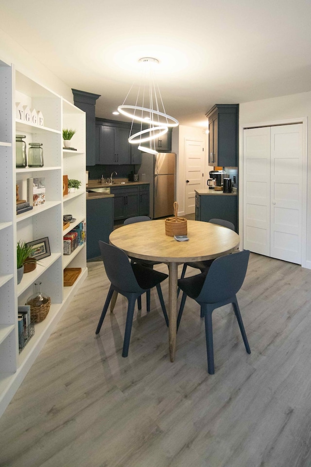 123 Bridge Run Ln Unit B, Lutsen Twp, MN 55612 - dining space with light wood-style flooring and a chandelier