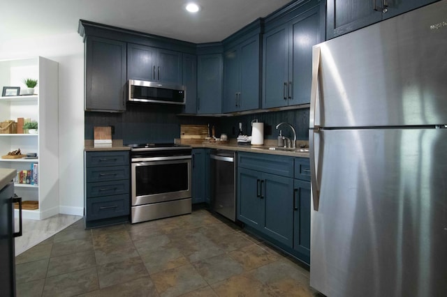 123 Bridge Run Ln Unit B, Lutsen Twp, MN 55612 - kitchen with appliances with stainless steel finishes, a sink, light countertops, tasteful backsplash, and recessed lighting