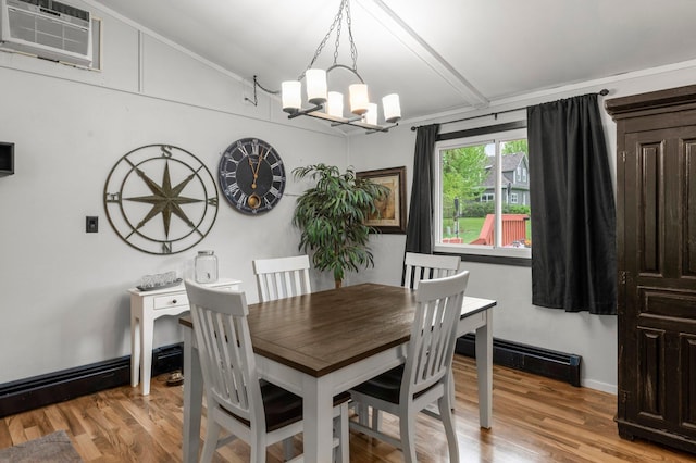 750 Prairie Ave SE, Cokato, MN 55321 - dining room with a chandelier, vaulted ceiling, baseboard heating, light wood finished floors, and a wall unit AC