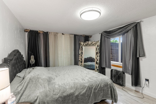 750 Prairie Ave SE, Cokato, MN 55321 - bedroom featuring a textured ceiling, baseboards, and light wood-style flooring