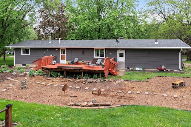 750 Prairie Ave SE, Cokato, MN 55321 - back of property featuring a wooden deck, a lawn, roof with shingles, and a chimney