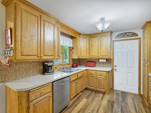 7349 Drew Ave N, Brooklyn Park, MN 55443 - kitchen featuring dishwasher, a sink, light wood finished floors, tasteful backsplash, and a textured ceiling