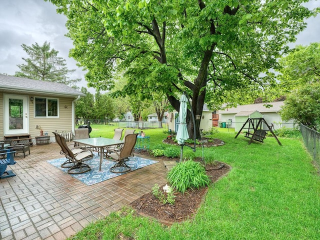 7349 Drew Ave N, Brooklyn Park, MN 55443 - view of patio with outdoor dining space and a playground