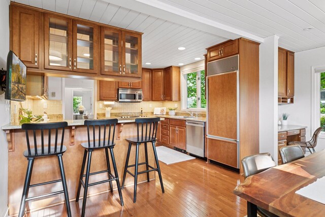 1215 Eleanor Ave, Saint Paul, MN 55116 - kitchen with stainless steel appliances, healthy amount of natural light, brown cabinetry, wood ceiling, and recessed lighting