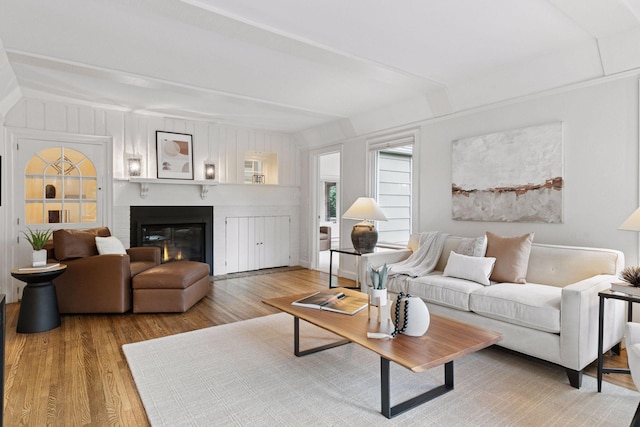 1215 Eleanor Ave, Saint Paul, MN 55116 - living area featuring light wood finished floors, a glass covered fireplace, and beam ceiling