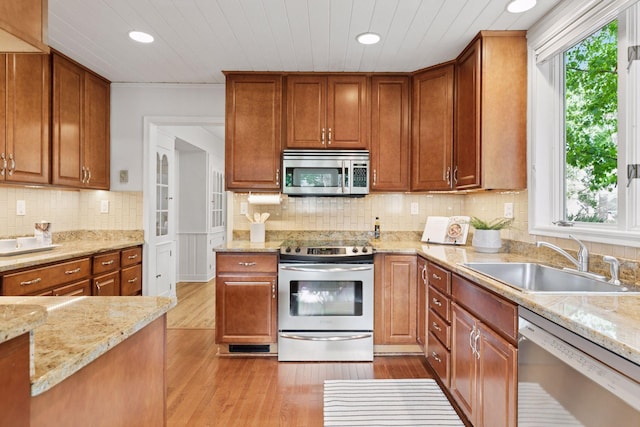 1215 Eleanor Ave, Saint Paul, MN 55116 - kitchen with stainless steel appliances, a sink, light wood finished floors, recessed lighting, and light stone counters