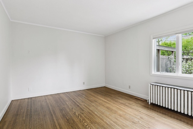 1215 Eleanor Ave, Saint Paul, MN 55116 - spare room featuring radiator, wood finished floors, baseboards, and ornamental molding