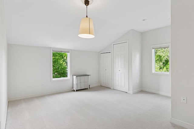 1215 Eleanor Ave, Saint Paul, MN 55116 - unfurnished bedroom with radiator heating unit, multiple windows, carpet, vaulted ceiling, and baseboards