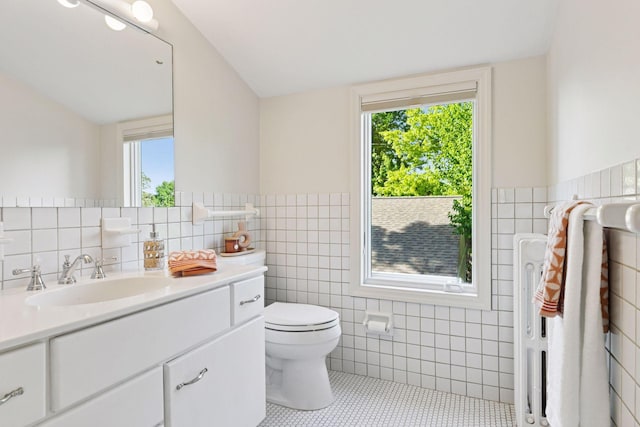 1215 Eleanor Ave, Saint Paul, MN 55116 - bathroom featuring tile walls, tile patterned floors, plenty of natural light, toilet, and vanity
