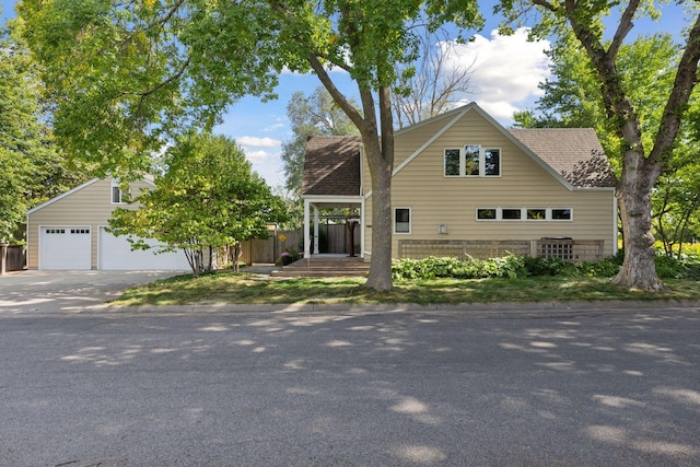 1215 Eleanor Ave, Saint Paul, MN 55116 - view of front facade with fence, roof with shingles, and a garage