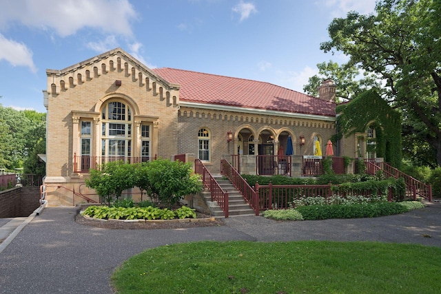 1215 Eleanor Ave, Saint Paul, MN 55116 - view of front of home with stairway, brick siding, covered porch, and a chimney