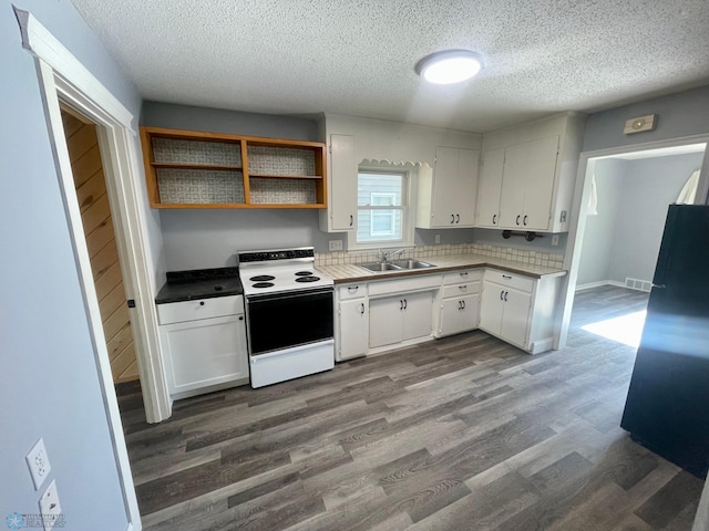 1630 7th St N, Fargo, ND 58102 - kitchen featuring range with electric stovetop, a sink, a textured ceiling, white cabinetry, and dark wood-type flooring
