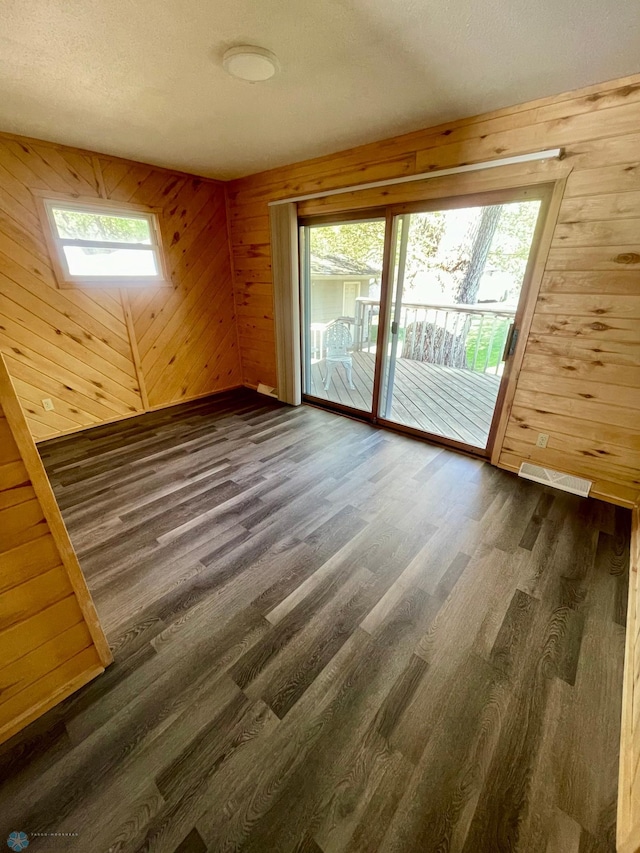 1630 7th St N, Fargo, ND 58102 - unfurnished room with wood walls, dark wood-style flooring, and a skylight