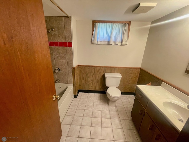 1630 7th St N, Fargo, ND 58102 - bathroom with toilet, wainscoting, vanity, tile patterned floors, and shower / bath combination