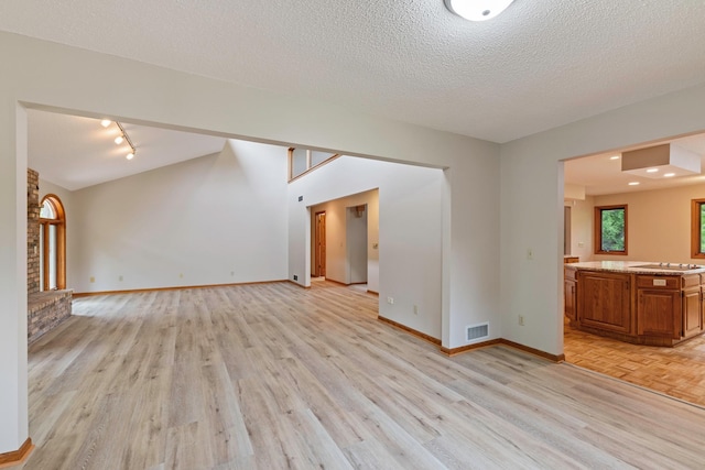 4306 Woods Way, Minnetonka, MN 55345 - unfurnished living room with light wood-style floors, baseboards, track lighting, and a textured ceiling