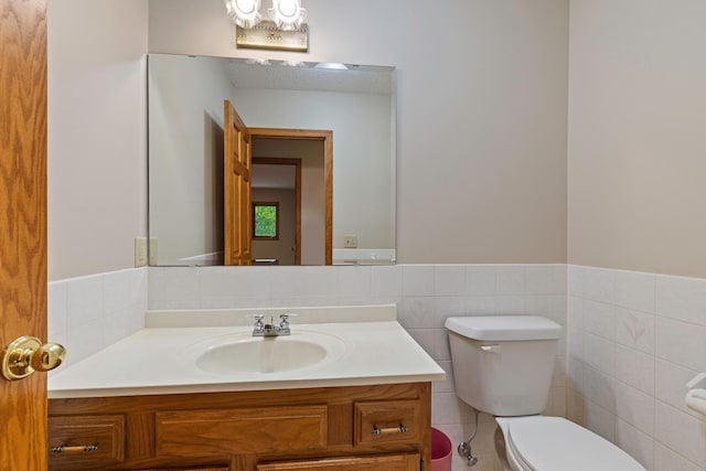 4306 Woods Way, Minnetonka, MN 55345 - bathroom with toilet, vanity, tile walls, and a wainscoted wall