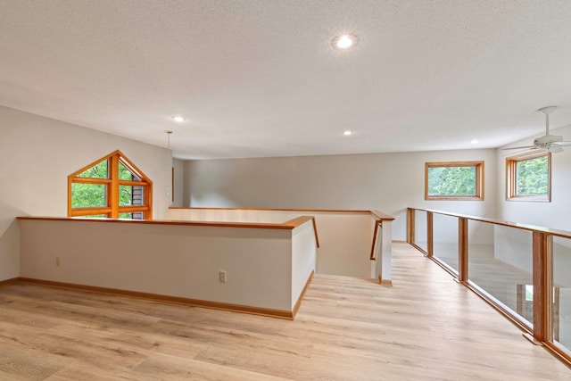 4306 Woods Way, Minnetonka, MN 55345 - empty room with light wood-type flooring, a ceiling fan, recessed lighting, baseboards, and a textured ceiling