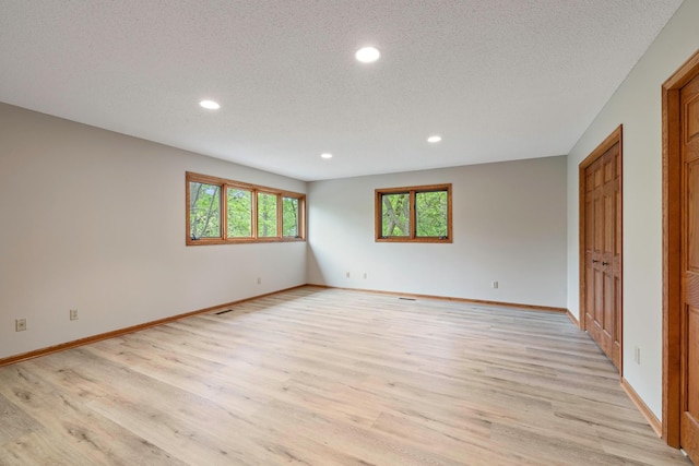 4306 Woods Way, Minnetonka, MN 55345 - spare room with recessed lighting, light wood-style floors, baseboards, and a textured ceiling