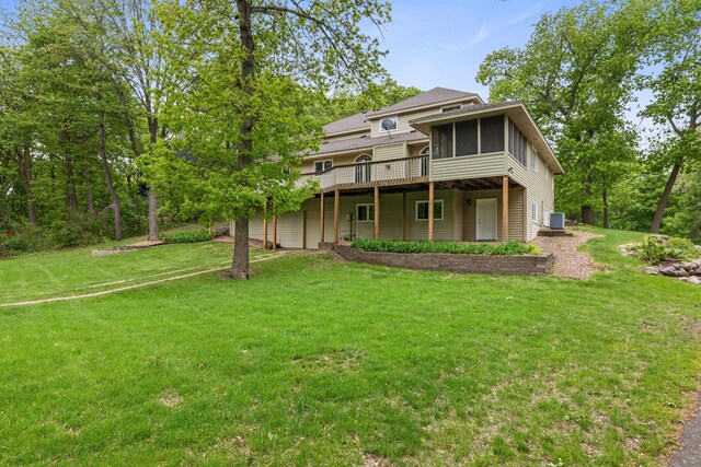 4306 Woods Way, Minnetonka, MN 55345 - rear view of house featuring a sunroom, a yard, a wooden deck, and central AC unit