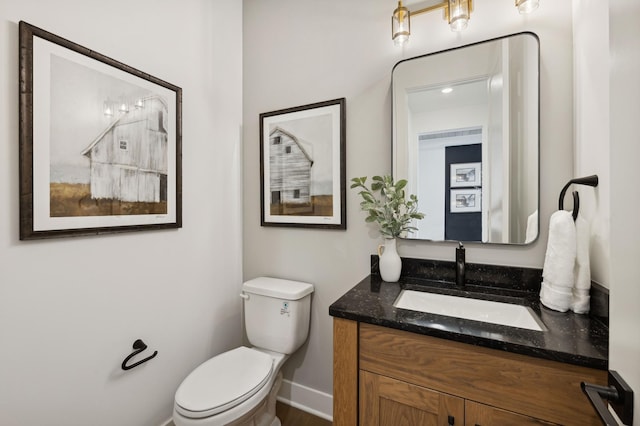 15630 112th St, Dayton, MN 55369 - half bathroom featuring toilet, vanity, and baseboards