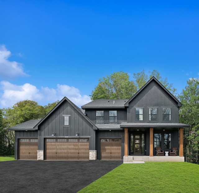 15630 112th St, Dayton, MN 55369 - modern farmhouse style home with asphalt driveway, a front yard, board and batten siding, a shingled roof, and a porch