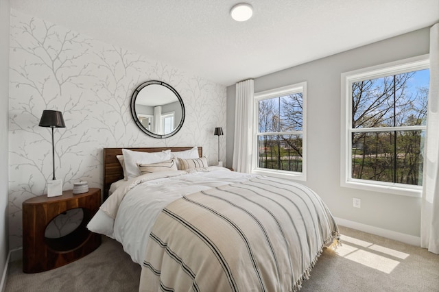 15630 112th St, Dayton, MN 55369 - bedroom featuring wallpapered walls, carpet, baseboards, an accent wall, and a textured ceiling