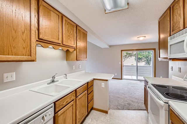 7293 Savanna Ct, Lino Lakes, MN 55014 - kitchen featuring white appliances, brown cabinetry, light countertops, light carpet, and a textured ceiling