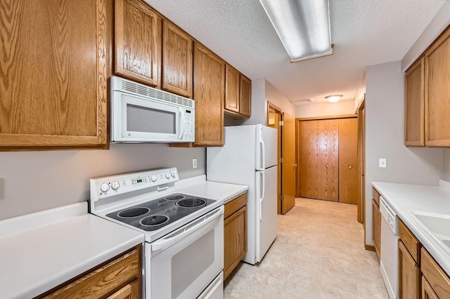 7293 Savanna Ct, Lino Lakes, MN 55014 - kitchen with white appliances, brown cabinets, light countertops, and a textured ceiling