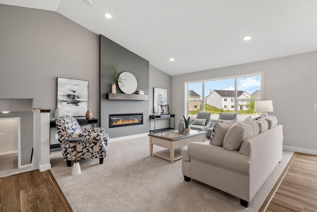 736 Blackbird Cir, Delano, MN 55328 - living area with baseboards, a fireplace, high vaulted ceiling, wood finished floors, and recessed lighting