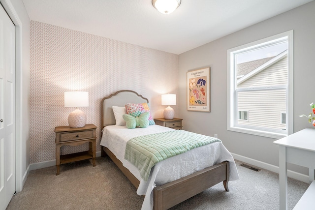 736 Blackbird Cir, Delano, MN 55328 - bedroom featuring baseboards, light carpet, a closet, and wallpapered walls