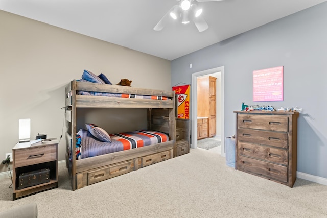 2508 4th Ave NW, Austin, MN 55912 - carpeted bedroom featuring baseboards, connected bathroom, and ceiling fan