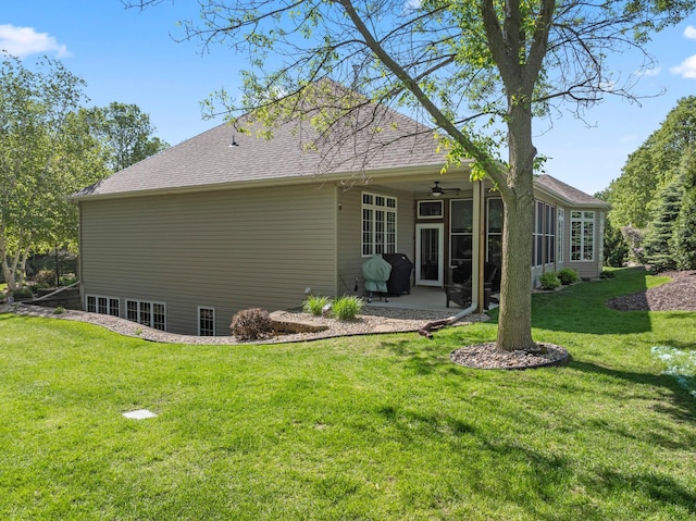 2508 4th Ave NW, Austin, MN 55912 - back of house with a ceiling fan, a yard, a patio area, and a shingled roof