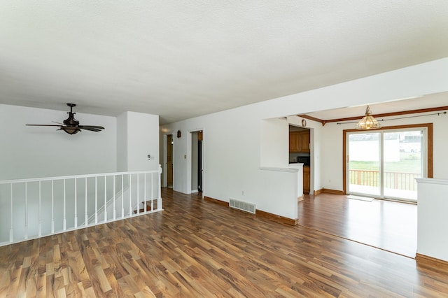 unfurnished living room with wood finished floors, ceiling fan, baseboards, and a fireplace