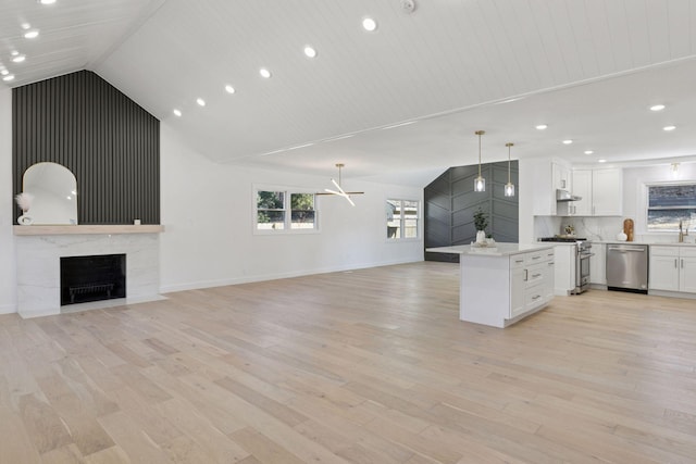 1022 Fairview Ave S, Saint Paul, MN 55116 - kitchen featuring appliances with stainless steel finishes, open floor plan, white cabinets, a high end fireplace, and recessed lighting