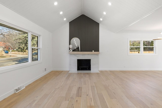 1022 Fairview Ave S, Saint Paul, MN 55116 - unfurnished living room featuring a high end fireplace, light wood-style flooring, recessed lighting, vaulted ceiling, and baseboards
