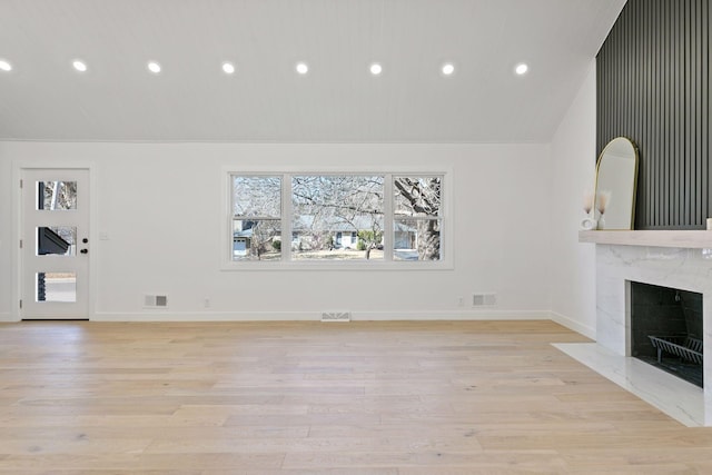 1022 Fairview Ave S, Saint Paul, MN 55116 - unfurnished living room with light wood-type flooring, a high end fireplace, recessed lighting, lofted ceiling, and baseboards