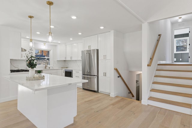1022 Fairview Ave S, Saint Paul, MN 55116 - kitchen featuring high end refrigerator, a sink, light wood-style floors, white cabinetry, and recessed lighting