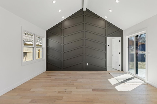 1022 Fairview Ave S, Saint Paul, MN 55116 - empty room featuring healthy amount of natural light, light wood-style floors, baseboards, recessed lighting, and a decorative wall
