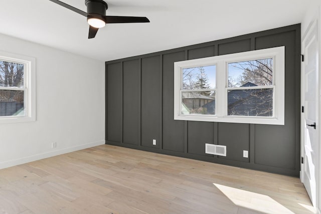 1022 Fairview Ave S, Saint Paul, MN 55116 - unfurnished bedroom featuring light wood finished floors, a decorative wall, a ceiling fan, and baseboards