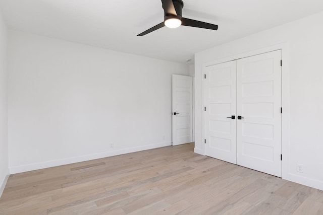 1022 Fairview Ave S, Saint Paul, MN 55116 - unfurnished bedroom with light wood-style flooring, baseboards, a closet, and a ceiling fan