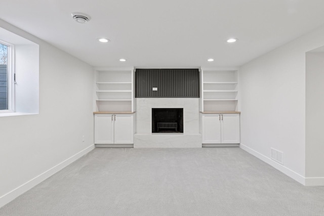 1022 Fairview Ave S, Saint Paul, MN 55116 - unfurnished living room with baseboards, carpet, recessed lighting, a premium fireplace, and built in shelves