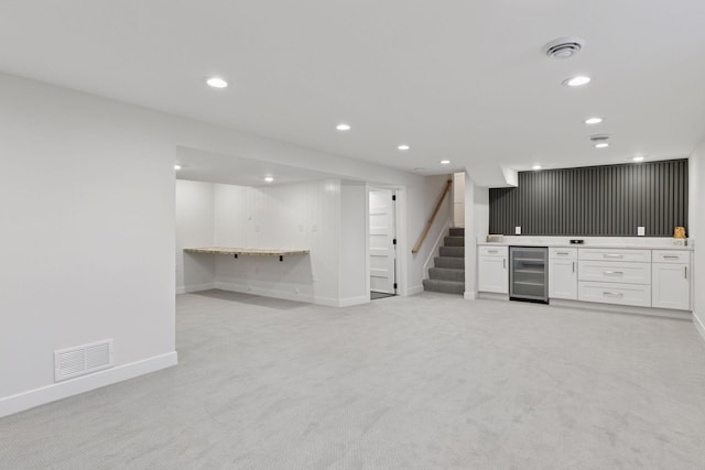 1022 Fairview Ave S, Saint Paul, MN 55116 - unfurnished living room with wine cooler, bar area, light colored carpet, recessed lighting, and baseboards