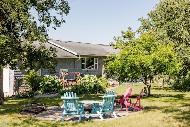 28040 Anchor Rd, Detroit Twp, MN 56501 - view of grassy yard featuring a patio and a fire pit