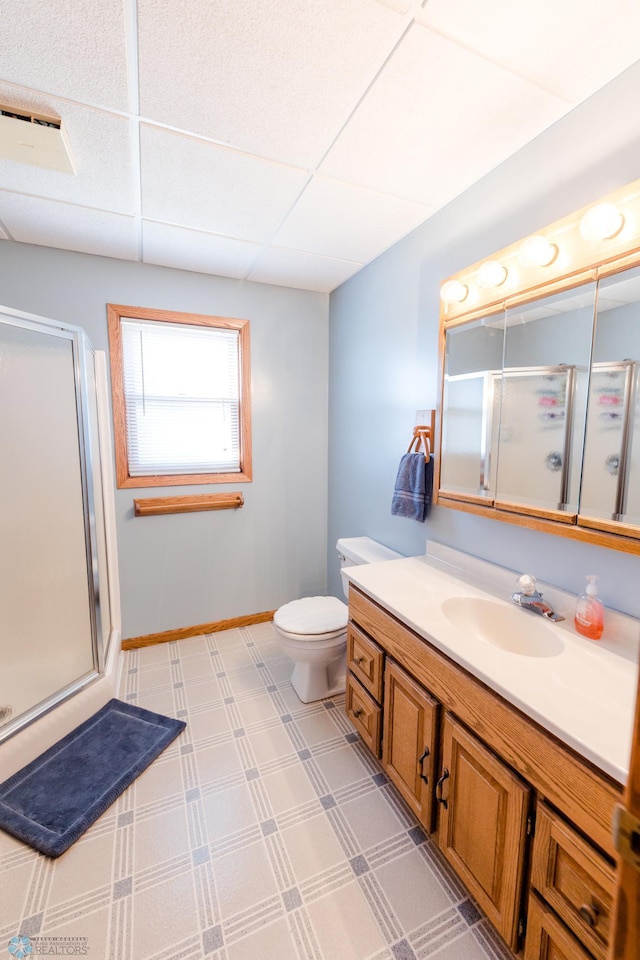 28040 Anchor Rd, Detroit Twp, MN 56501 - bathroom featuring a stall shower, vanity, toilet, a paneled ceiling, and baseboards
