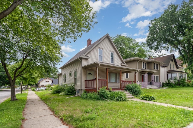1430 Penn Ave N, Minneapolis, MN 55411 - view of front facade featuring a porch, a chimney, and a front lawn