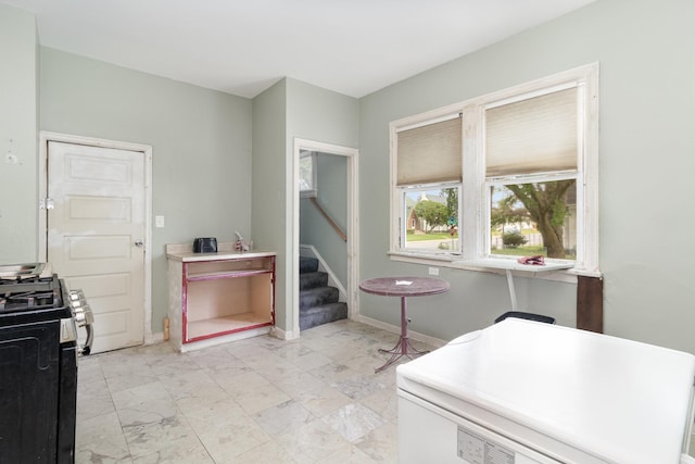 1430 Penn Ave N, Minneapolis, MN 55411 - kitchen featuring range with gas cooktop, refrigerator, baseboards, and light marble finish flooring