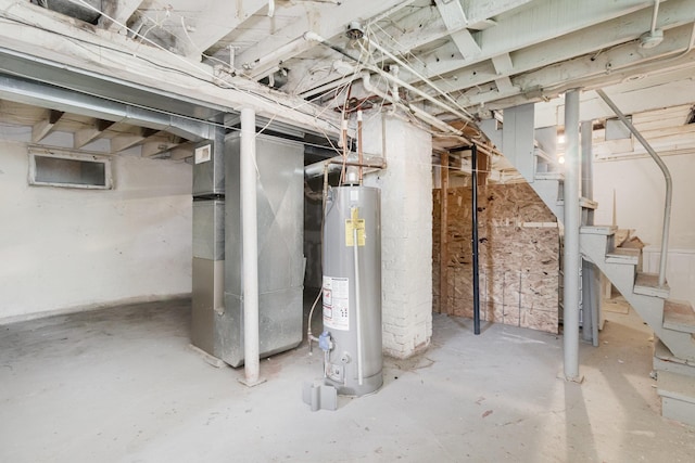 1430 Penn Ave N, Minneapolis, MN 55411 - unfinished below grade area featuring water heater, heating unit, and stairs